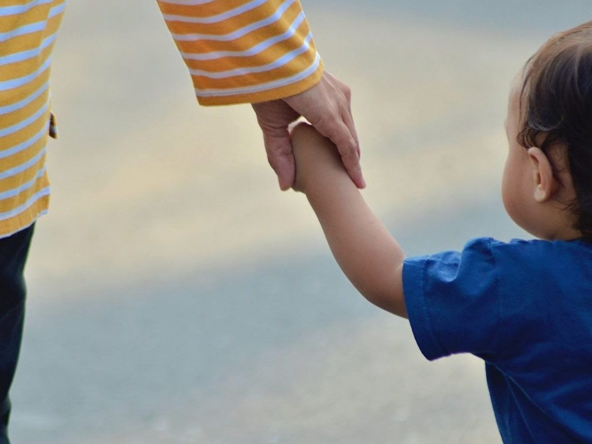 Mum holding baby's hand